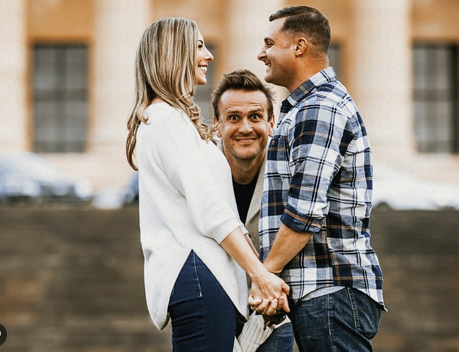 guy hiding between couple